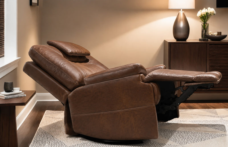Brown leather recliner chair in a living room setting with a lamp and flowers on a side table.