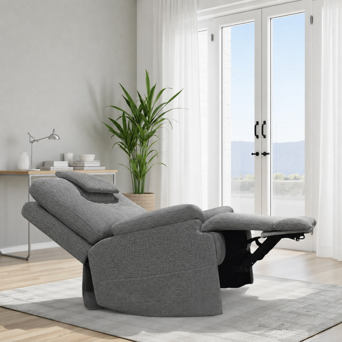 Gray recliner chair in a modern living room with a plant and desk.